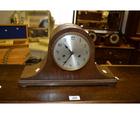 A 1930s Napoleon Hat oak mantel clock, silvered 12cm dial with Arabic numerals, beaded band, 25cm high, 39.5cm wide 