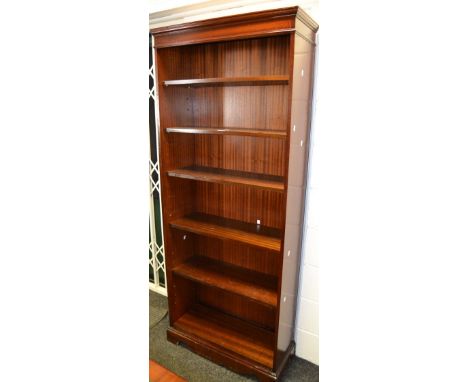 A 20th century mahogany bookcase, open shelves, shaped apron, bracket feet