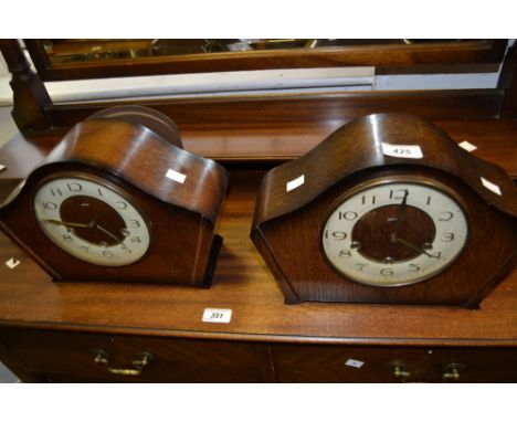 A Smiths bowed oak mantel clock, the 15cm dial with Arabic numerals, movement striking on a gong, 23cm high, 32cm wide, c. 19