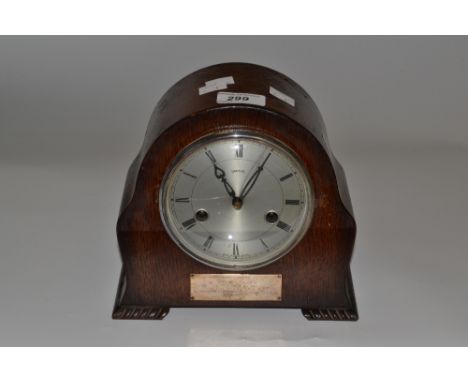 A Smiths oak mantel clock, 11cm dial with Roman numerals, label engraved 'Presented to L.F.Austin By the Boys of the 2nd Batt