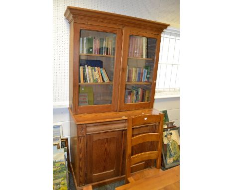 A 20th century pine dresser, glazed doors, two short shaped drawers over two doors, bracket feet