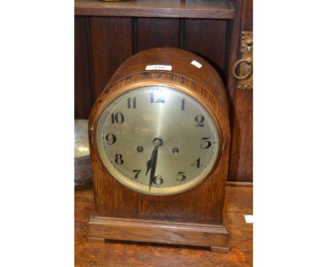 A 1930s oak dome top mantel clock, the 18.5cm dial painted with Arabic numerals, the eight day movement striking on a gong, 3