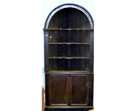 A Victorian mahogany corner dresser, domed top, open shaped shelves, moulded apron, bracket feet