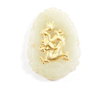 A Chinese jade necklace pendant. The pendant having a gilded Qilin motif to the center of a scrolled framed cartouche having 