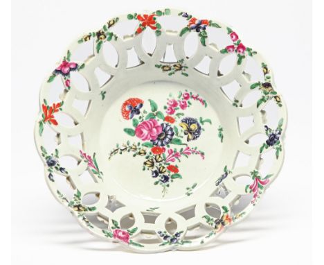 A Worcester yellow-ground openwork basket, c1768-70, painted with a loose bouquet and scattered flowers, the exterior with po