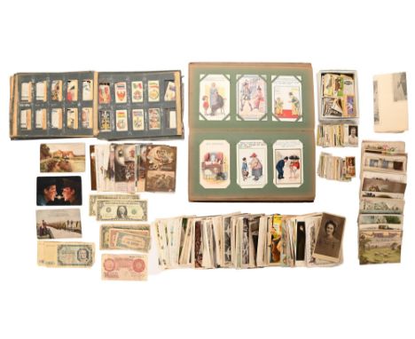 An Edwardian album of postcards, first half 20th c, mostly comic, including Donald McGill, postally used and unused, pastedow