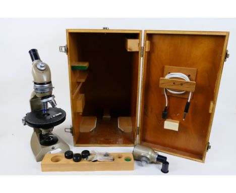 A Vickers Instruments monocular microscope in fitted wooden case with accessories. [W]
