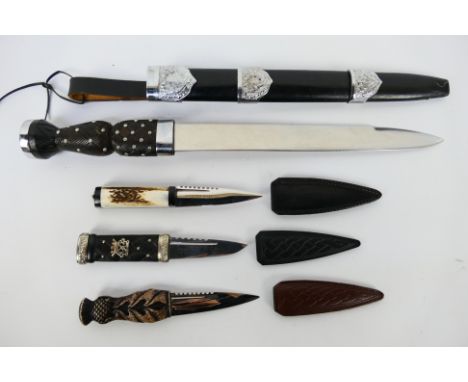 A Dirk with 29 cm (l) thistle decorated blade and three Sgian Dubh. [W]Note: This lot is not for sale to people under the age
