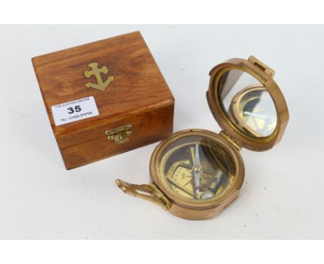 A natural sine brass cased compass with dual spirit level marked Stanley London with natural sine table to outer case, contai