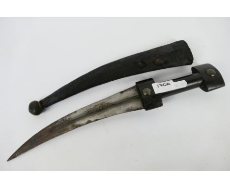 An antique jambiya, probably Ottoman, 24 cm (l) blade having medial ridge with horn grip, contained in scabbard. [W]Note: Thi