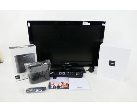 A boxed Bose Soundlink Color 2 speaker, appears unused and a 21" television with remote. [2]. [W]