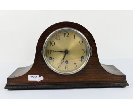 A Napoleons hat mantel clock with key and pendulum. [W]