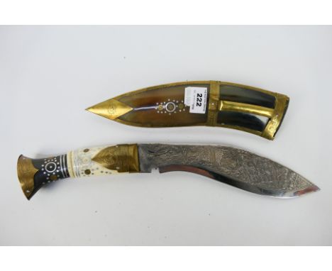 A vintage Kukri knife with bone and horn handle with decorative brass mountings, contained in brass mounted scabbard, blade 2