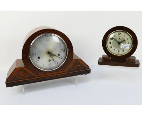 A Napoleon Hat oak cased mantel clock, Haller movement, Arabic numerals on a silvered dial, Westminster chimes, with pendulum