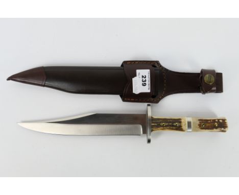 A Linder 440C Kentucky Bowie knife with 20 cm (l) blade and four piece antler grip, contained in sheath. [W]Note: This lot is