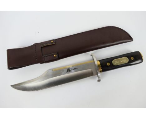 A large Bowie type knife, a replica of John Wayne's knife from The Alamo, marked The Alamo to the blade and with gilt plaque 