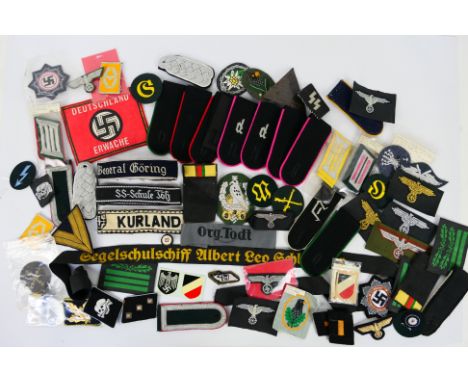 A collection of World War Two (WW2 / WWII) style German insignia to include collar tabs, epaulettes and similar. [W]