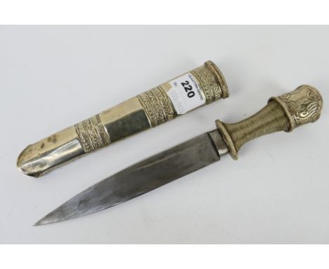 An antique Bhutanese dagger with white metal scabbard and pommel and wire bound grip, 16.5 cm (l) blade. [W]Note: This lot is