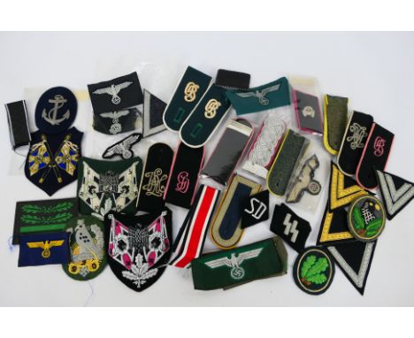 A collection of World War Two (WW2 / WWII) style German insignia to include collar tabs, epaulettes and similar. [W]