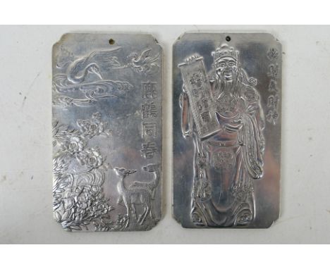 Two Chinese white metal trade tokens / plaques one decorated with cranes and deer, the other with a bearded gentleman brandis