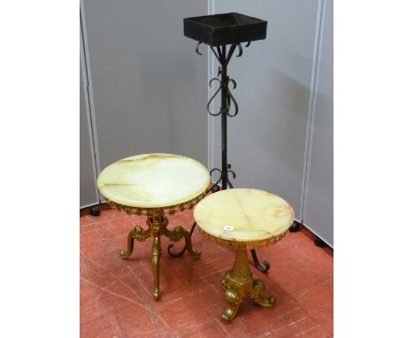 Two onyx and brass circular topped side tables, 35 and 43 cms diameter and a wrought iron planter stand