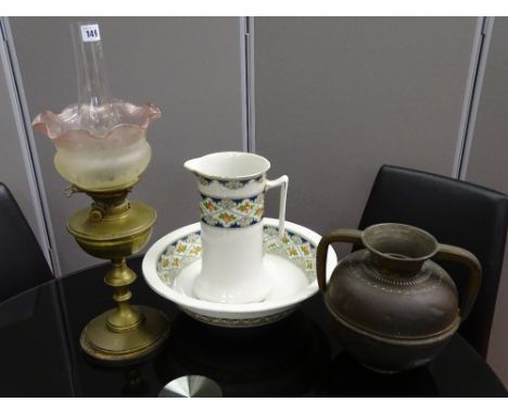 Vintage brass oil lamp with cranberry frill shade (chipped), a Victorian wash jug and bowl and a brass two handled bulbous ju