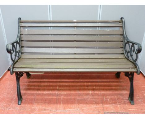 A wooden slatted bench with cast iron ends