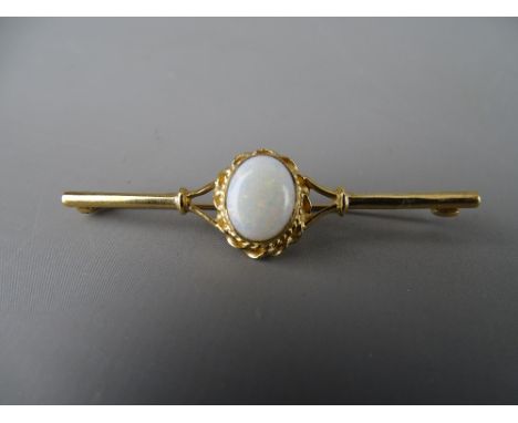 Nine carat gold bar brooch with oval centre opal in a twist mount, 1 x 0.8 cms, 3.4 grms gross