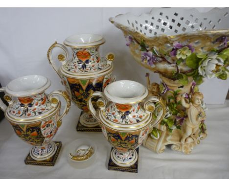 Garniture set of three 'Old Derby Imari' campana style vases and a Continental porcelain figure and floral encrusted comport 