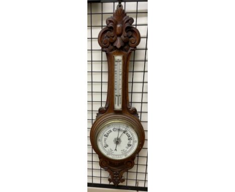 An oak cased aneroid barometer with a mercury thermometer