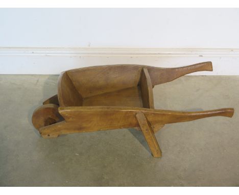 An ornamental wooden wheelbarrow suitable for use as a planter 76cm long - in good restored and clean waxed condition 