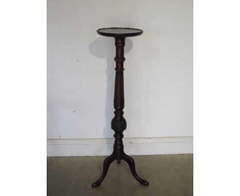 An early 20th century mahogany torchere raised upon a tripod base, approximately 101cm, with old repair to one foot 