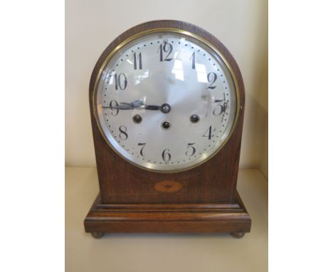 An 8 day oak case mantle clock by Junhams, quarter hour Westminster chimes 7.5 inch silvered dial, condition report - working