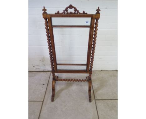 A Victorian walnut fire screen with sugar barley twist supports - 98cm H x 47cm W 