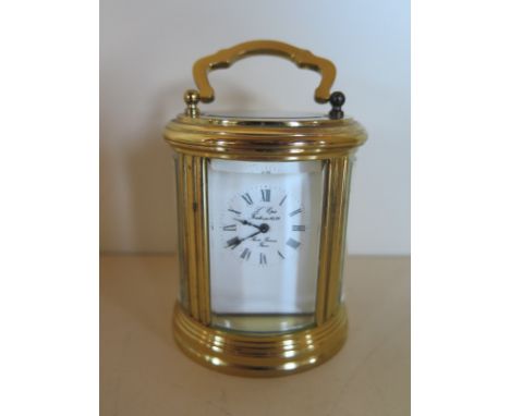 A small L’Epie cylindrical carriage clock with Roman numeral dial, approximately 8cm high, 6.5cm oval, adjust and winds but d