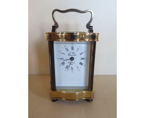 A L’Epie carriage clock with serpentine sided brass case and a Roman numeral dial, approximately 11.5cm high, 8cm wide, 7.5cm
