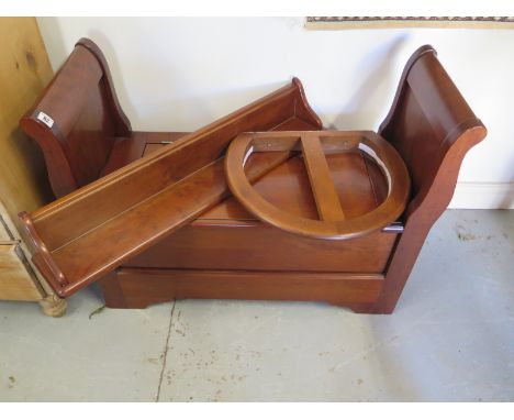 A mahogany childs bench with lift up seat and wall bracket, for a curtain and a wall shelf, originally from Simon Horn Nurser