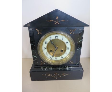 A slate 8 day striking mantle clock with key and pendulum - 36cm tall, ticks but stops 