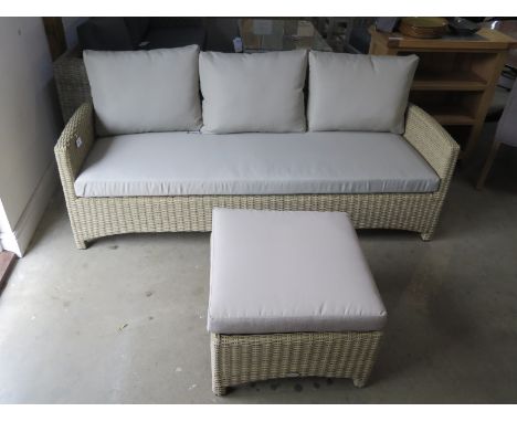 A Bramblecrest Cotswold three seater garden sofa and a coffee table 