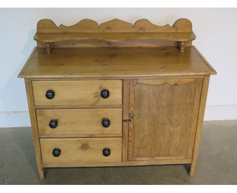 A Victorian stripped pine dresser with single cupboard and three drawers with up-stand on bobbin supports - 99cm H x 112cm x 