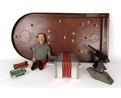A toy model of a ventriloquist doll, a tinplate tank, a model train, a model car, a toy gun, a child's accordion and a bagate