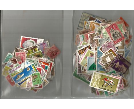 British Commonwealth stamp collection accumulation stamps on paper in two bags a lot of items over 50 years old. Good Conditi