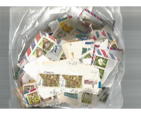 British Commonwealth stamp collection accumulation of stamps on paper in bag a lot of the items are more than 50 years old. G