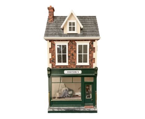 Good quality late 20th century dolls house by M. James dated 1996 in the form of 'Graysons' Shop with two storeys above; text