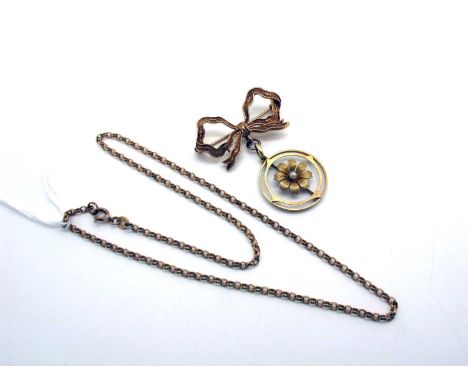 An Edwardian Style Openwork Pendant, stamped "15c", suspended below a 9ct gold bow brooch; together with a 9ct gold chain.