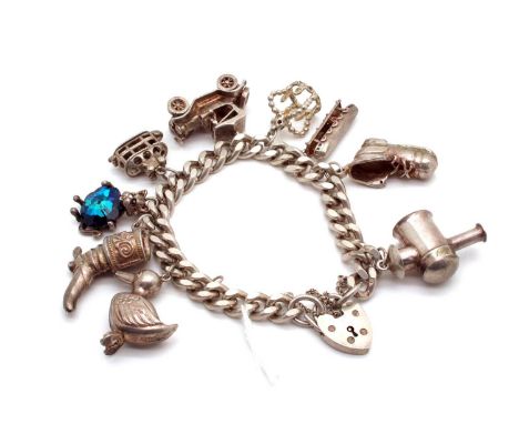A Curb Link Charm Bracelet, to hallmarked silver heart shape padlock style clasp, suspending novelty charm pendants, includin