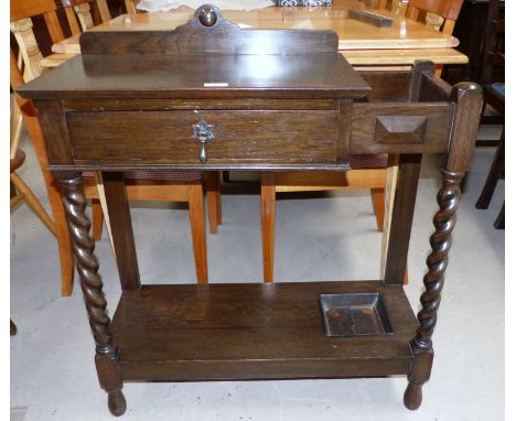 A 1930's oak hall/stick stand with barley twist legs