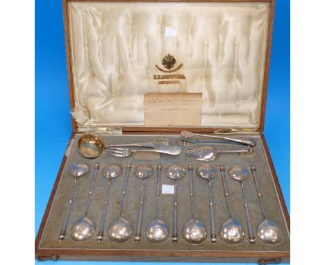 An early 20th century Russian silver dessert cutlery service comprising 12 spoons, sifter spoon, sugar tongs, fork and shovel