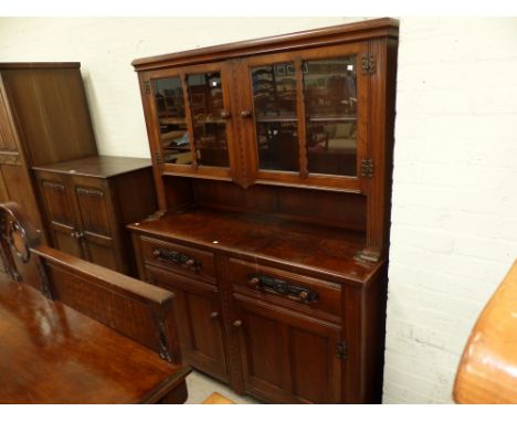 An Edwardian oak side cabinet with 2 panel doors, 2 drawers and 2 glazed cupboards over