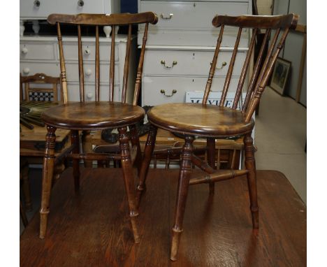 A matched set of 12 late 19th/early 20th century beech stick back kitchen chairs with solid seats and turned legs (one painte